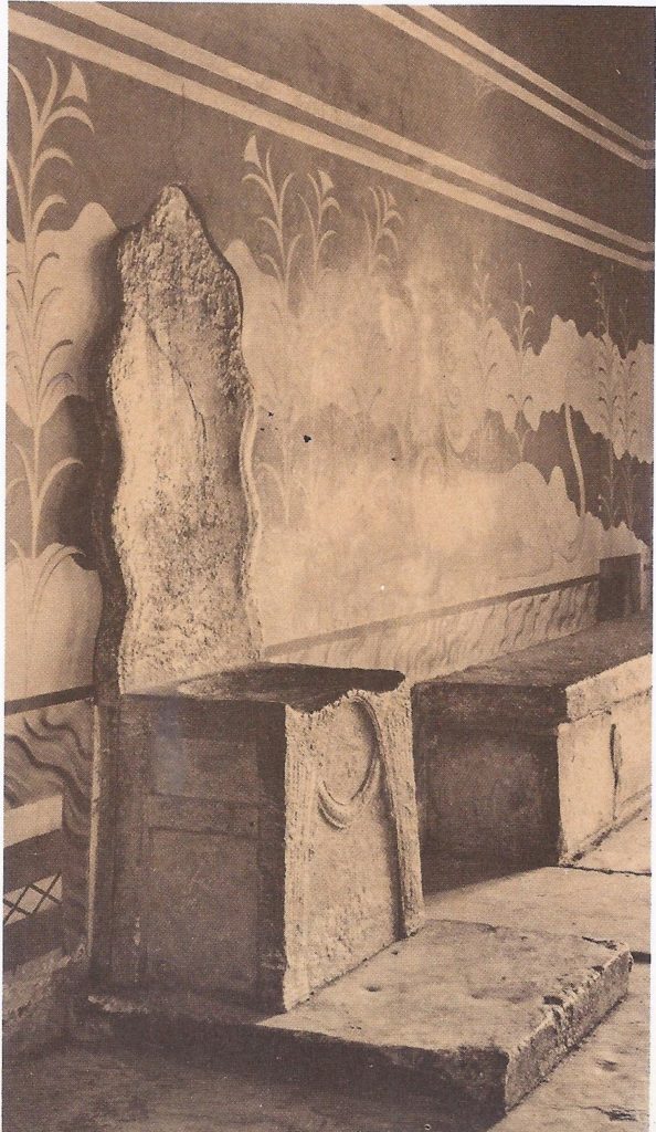 The alabaster throne o the rulers of Crete, in the throne room of the palace of Knossos. The frescoes on the wall behind are modern reconstructions carried out by Sir Arthur Evans.