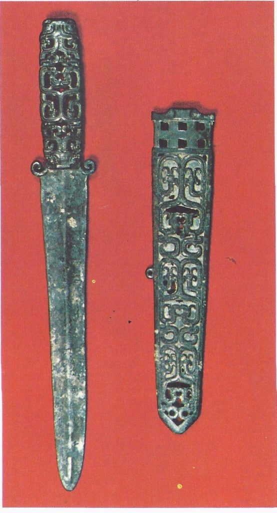 Bronze dagger and scabbard (Chou dynasty, seventh to sixth century B.C.), which owes much to nomadic influence both in its shape and in its decoration. The interlacing motif is probably derived from plaited ropes and leather thongs used by the nomads for their harness gear.