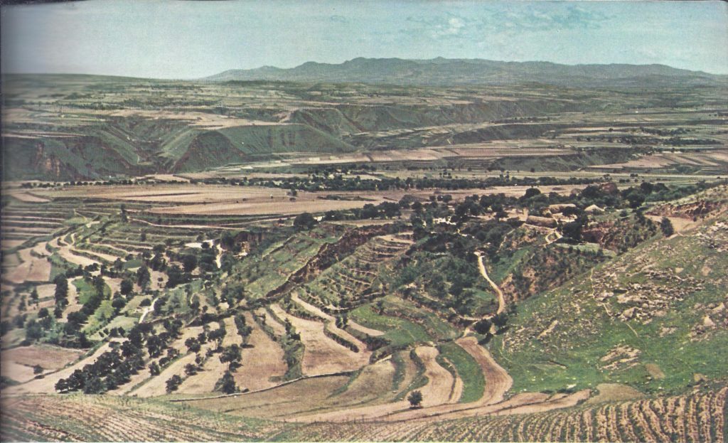 Typical north China scenery in the neighbourhood of Sian, with agricultural terraces on the slopes of the hills. It is through landscape such as this that the Great Wall runs for much of its length.