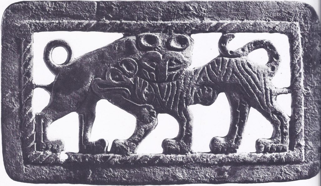 Bronze buckle with motif of struggling beasts, typifying the nomadic themes and vigorous execution of much early Chinese art.