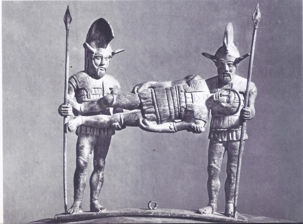 Two Etruscans carry a wounded comrade, from the lid of an urn. The Etruscans, too, were among the armies of Rome, ranged against Hannibal.