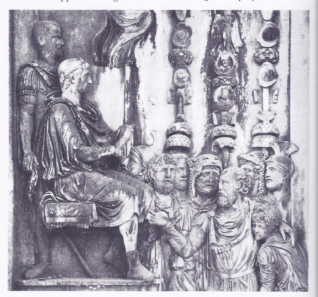 A defeated opponent submits to the Emperor ; from the Arch of Constantine